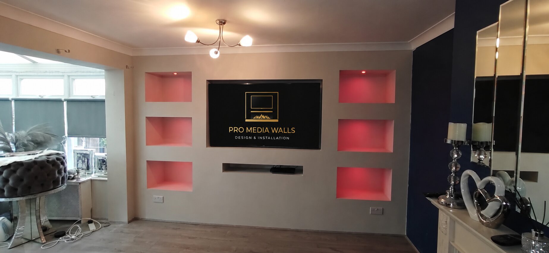 Minimal luxury media wall with ambient LED lighting and floating shelf detail